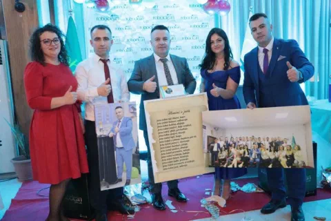 Group holding a framed photograph